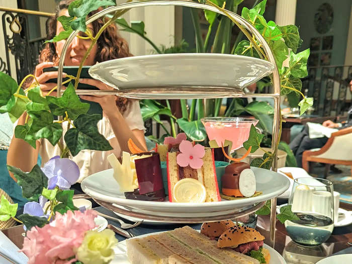 Next, the food arrived on a gorgeous, three-tiered cake stand with dainty flowers and leaves wrapped around it.