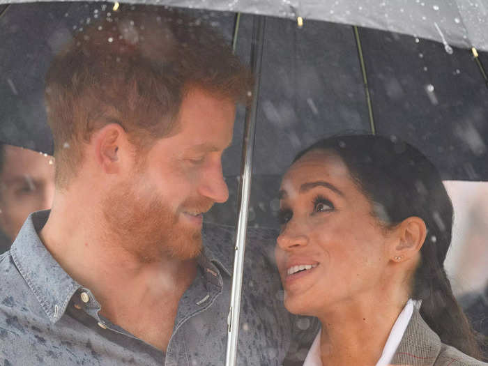 The newlyweds set off on their first royal tour months after the wedding. During a rainy stop in Australia, Markle and Harry were seen huddling up beneath an umbrella.