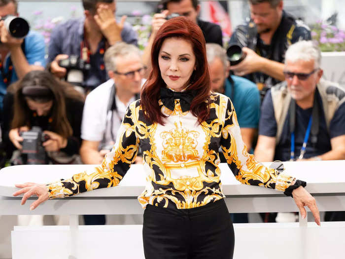 During a photo call for "Elvis" during the 75th annual Cannes film festival in May 2022, Presley wore a gold and black printed shirt and sleek black trousers.