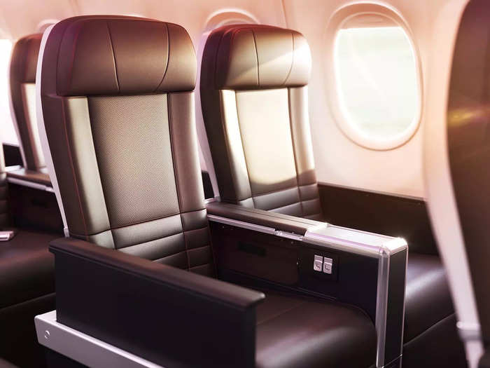 A 46-seat Premium cabin is located behind the Upper Class section, featuring a leg rest, deep recline, a 13.3" touchscreen with Bluetooth, and in-seat wireless charging. The seats boast 38" of pitch.