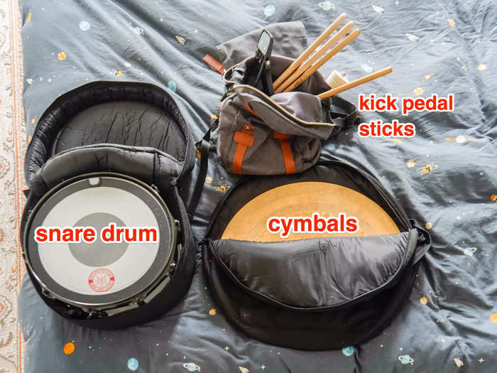 My acoustic drum parts — the snare drum, cymbals, kick pedal, and sticks — all fit in three storage bags under my bed.