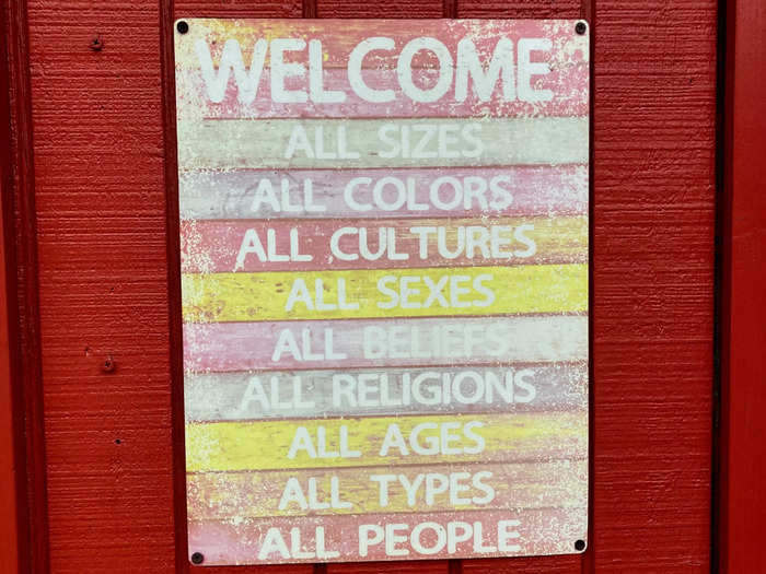 The inclusivity sign hanging outside Rainbow Cattle Company reminds visitors that the watering hole is a safe and welcoming space.