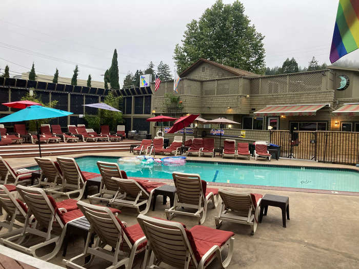 The hotel has a pool and plentiful chairs to lounge in.