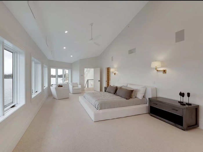 The renovated home has a white color scheme, with five bedrooms and six full bathrooms.