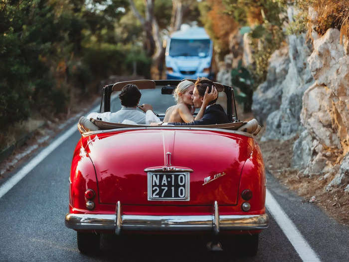 The newlyweds drove a red convertible to their reception.