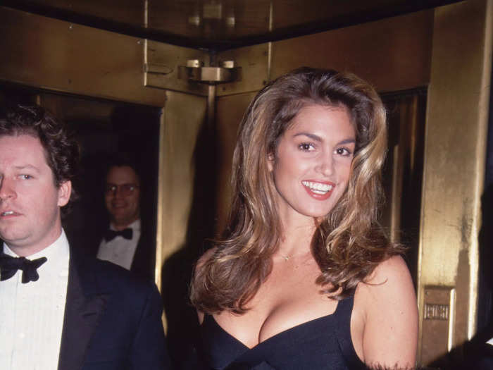 Cindy Crawford stunned in a black Hervé Léger bandage dress at a party in 1998.