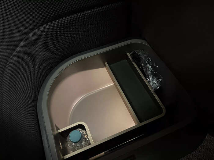 There was also a hidden compartment under the second cushion, which had a water bottle and noise-canceling headphones for the flight.