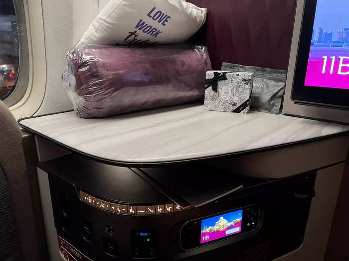 The overall aesthetic in the business-class cabin is luxe, and each seat was decorated with two pillows, a Diptyque amenity kit, noise-canceling headphones, and a plush blanket.