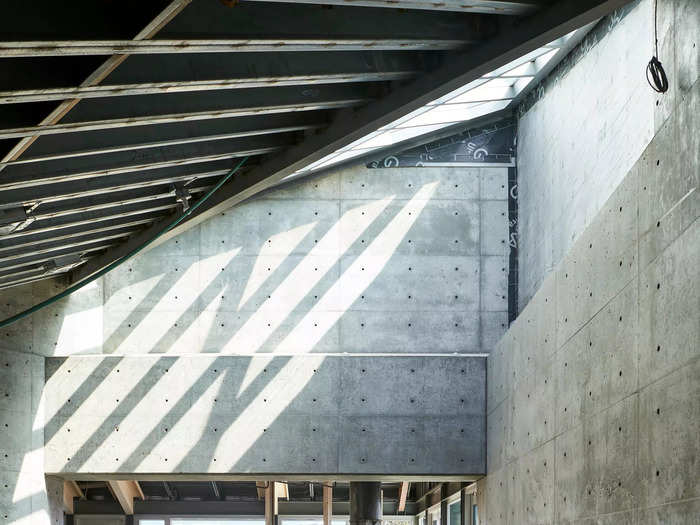 The concrete walls, black soapstone floors, and zinc roof give the home a classic grey "bunker" look.