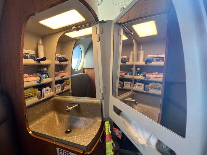 The sink comes fully stocked with first aid items and toiletries, like band-aids and mouthwash. There is also a large mirror on the inside of the door.