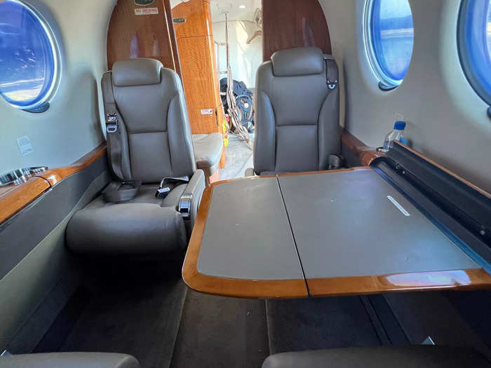 Between each set of loungers is a large, sturdy table that folds out from the fuselage wall.