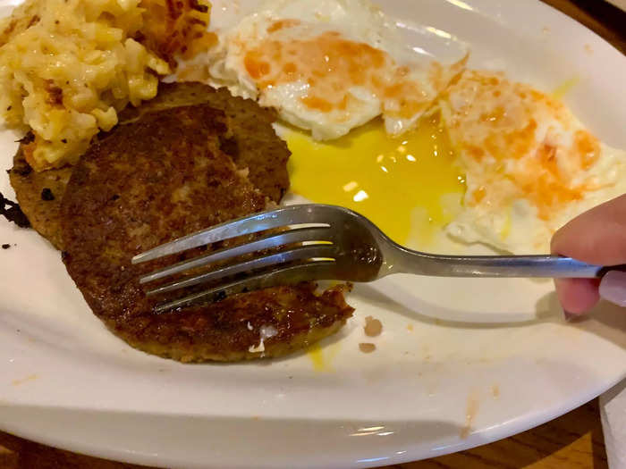 I ordered the sausage, fried eggs, and the cheese casserole dish, which came with a side of biscuits and gravy.