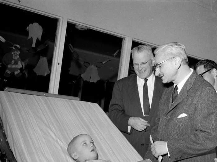 December 17, 1959: 5-year-old Mark Stacey is visited by Dr. Albert Sabin (right) and Dr. Walter Langsam (left) at Cincinnati