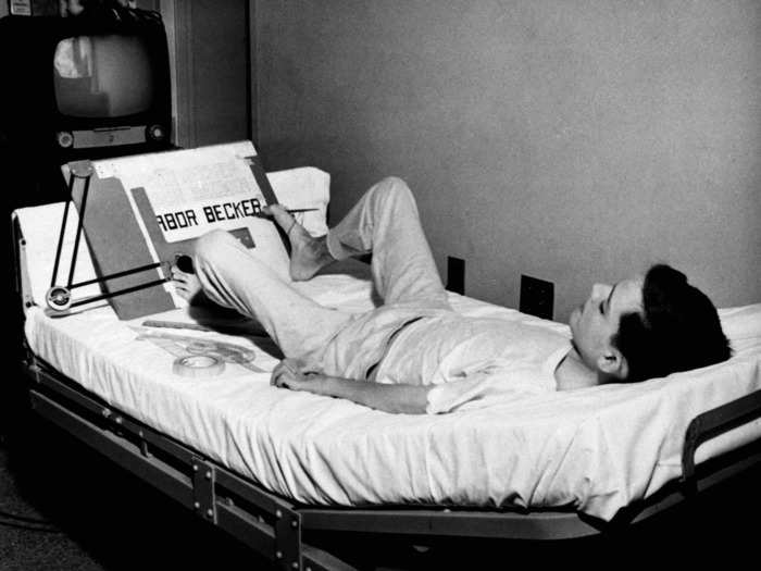 January 8, 1955: Polio patient at the Respirator and Rehabilitation Center in Omaha, Nebraska, Larry Becker, draws a hospital floor plan using his right foot due to his paralysis.