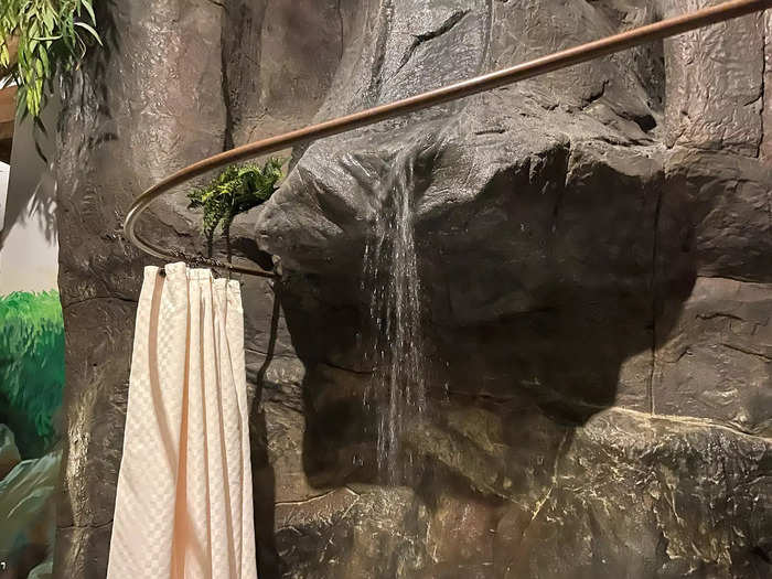 Along the wall, there was a switch that redirected the water either to fill the tub or turn on the waterfall feature. The only privacy was a wraparound shower curtain.