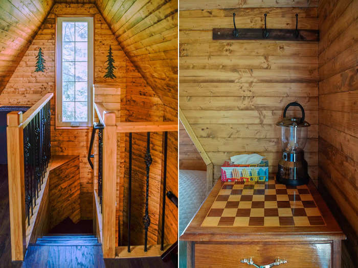 Upstairs was a loft bedroom where I slept. Here, the treehouse theme continued with wooden walls and nature-inspired wall art.