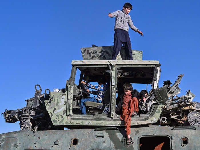 Here, young kids make a playground of destroyed military vehicles, a reminder of the country