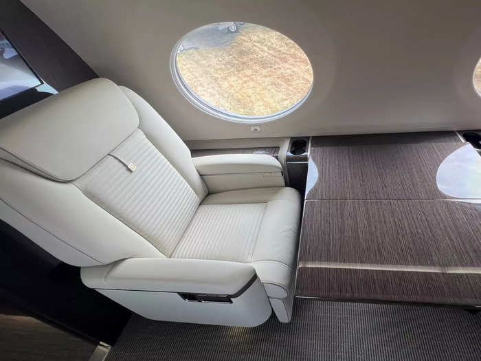 Moreover, tables are built into the side of the fuselage and fold out between each set of seats at the push of a button.