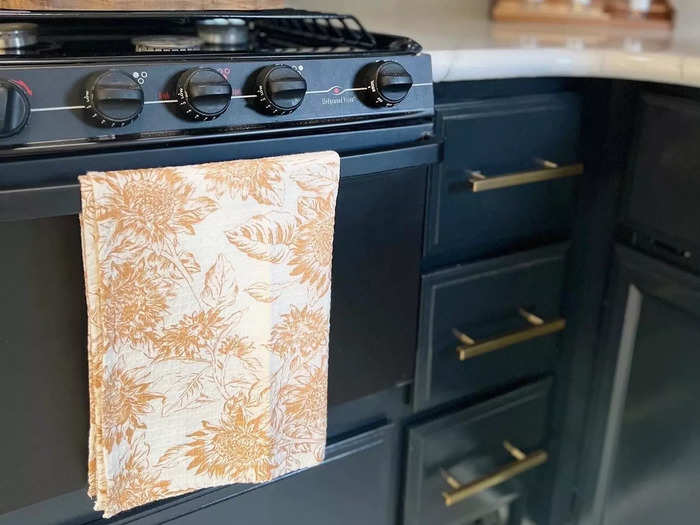 She painted the cabinets a blue-black color and replaced the handles.