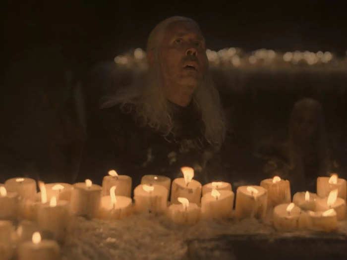 Viserys holds his hands over the flames of the candles for an unnaturally long time, which may be an allusion to the debate over if Targaryens are fireproof.