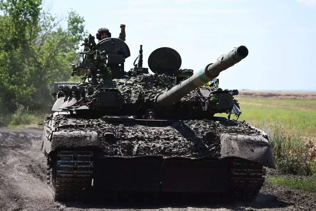 Ukrainian servicemen drive a T-72 tank on the frontline in eastern Ukraine on July 13, 2022, amid the Russian invasion of Ukraine.