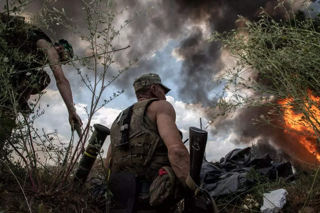 Paratroopers from the 81st Airmobile Battalion takes shelter in a trench from a BM-21 Grad multiple rocket launcher attack which has destroyed a neighboring house on July 5,2022 in Seversk, Ukraine.