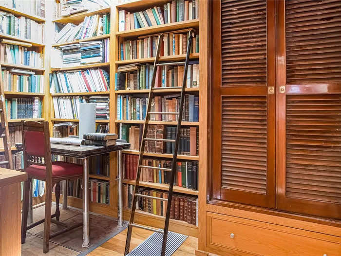 The library and study room has a built-in bookshelf with a ladder for the higher shelves.