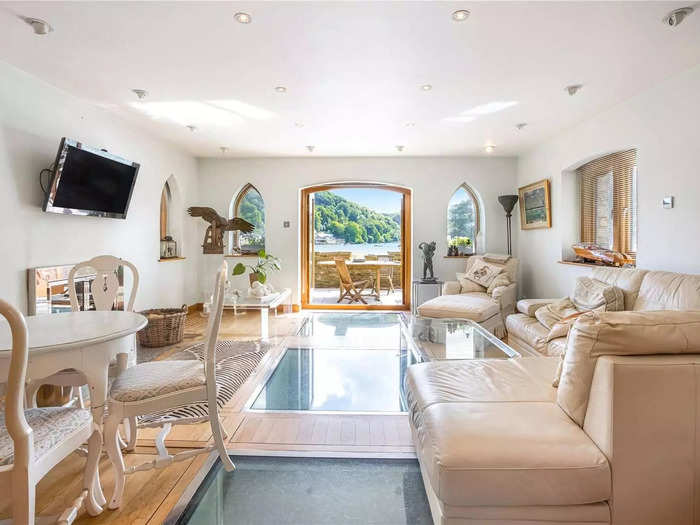 The kitchen leads into the living area. This room has glass paneling on the floor, which gives a bird