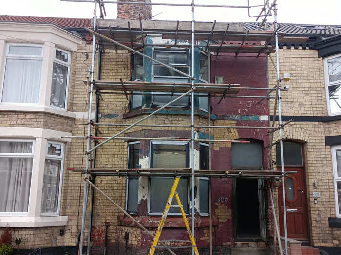 Even the exterior was in bad shape: The paint was chipped and the roots of a budding tree had damaged the brickwork on the house