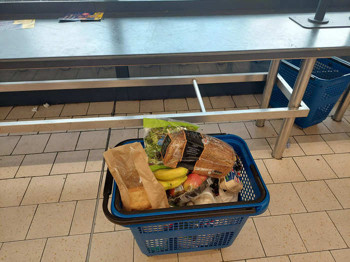 Lidl stores are designed to maximize efficiency. This includes bag packing. Rather than packing your bags at the checkouts like at other UK supermarkets, at Lidl shoppers simply put their scanned items back in their baskets to save on time. A table behind the checkouts gives customers space to then sort their purchases into bags.
