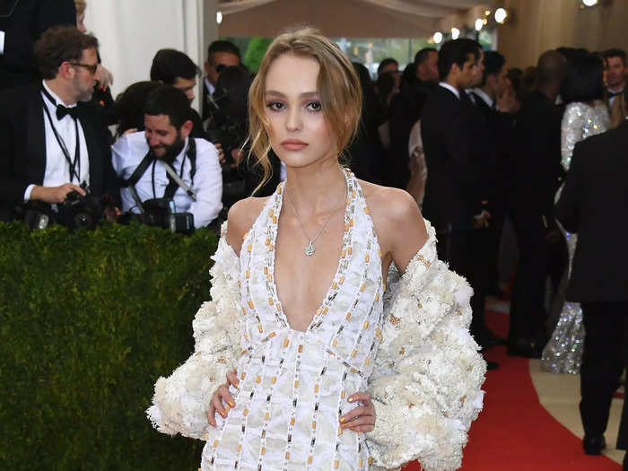 Lily-Rose Depp wore an embroidered white halterneck maxi dress and matching shrug to the 2016 Met Gala.