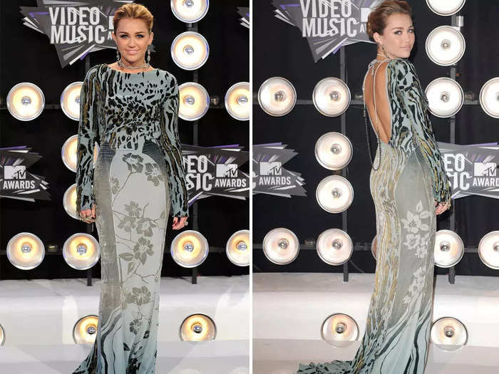 Then in 2011, Cyrus played it safe by wearing a grayish blue, long-sleeved gown.