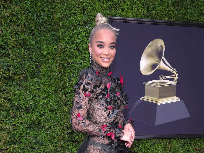 In a black lace and tulle gown with head-to-toe butterflies on it, Jasmine Sanders walked the 2022 Grammy Awards red carpet.