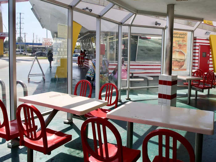 White tables and floating red seats felt like vintage fast food, and seemed fitting,