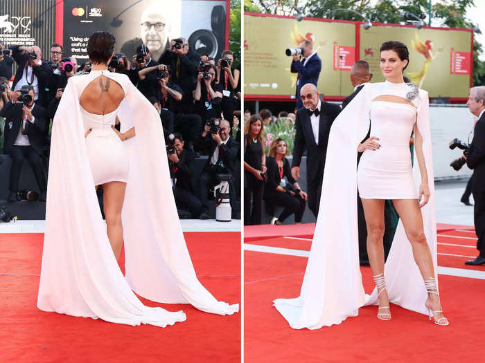 Isabeli Fontana arrived in a statement minidress with billowing cape sleeves that reached the floor.