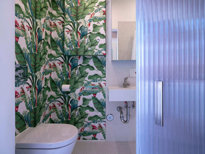 Elsewhere in the home is a tropical-themed bathroom, separated from the rest of the space by a door made from translucent polycarbonate.