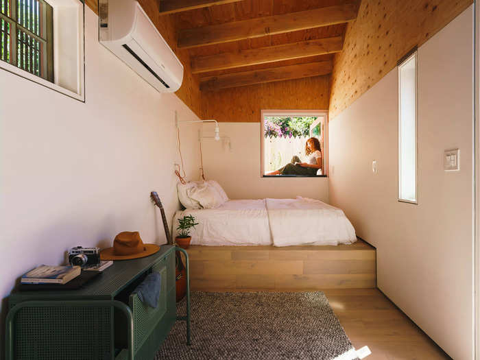 Post-renovation, the guest house features a lofted bed positioned by a window ledge that Saxman says doubles as the perfect reading nook.