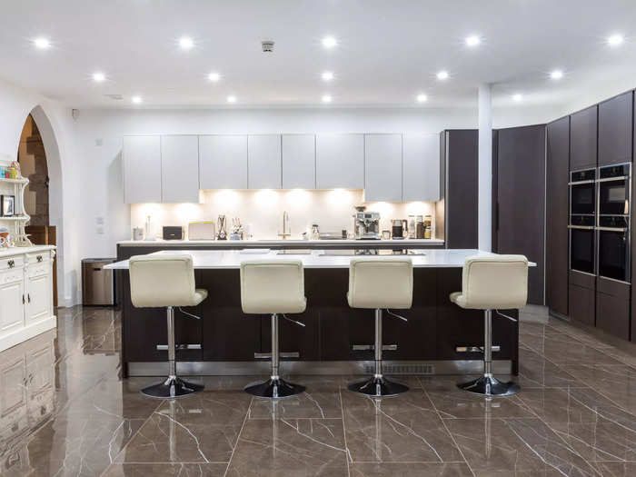 The dining area leads into a bespoke modern kitchen.