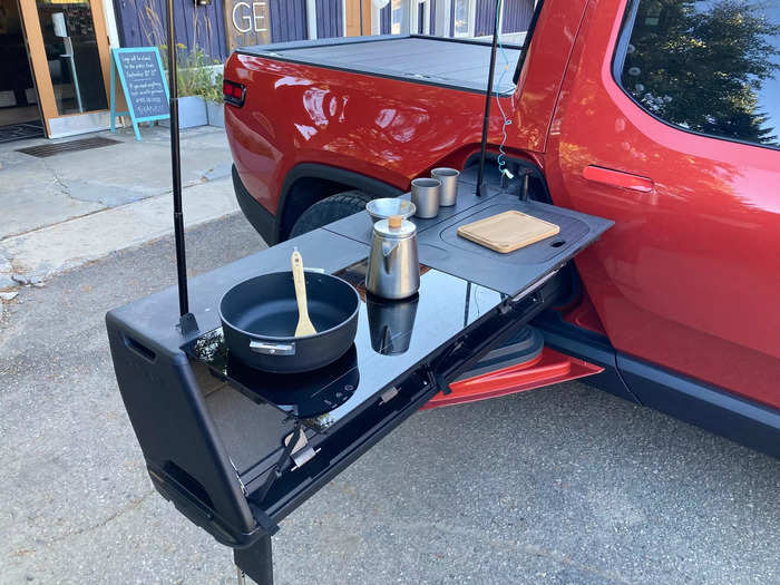 The company plans to sell its own trunk-mounted camping kitchen down the line, similar to the slide-out kitchen available on its R1T pickup truck.