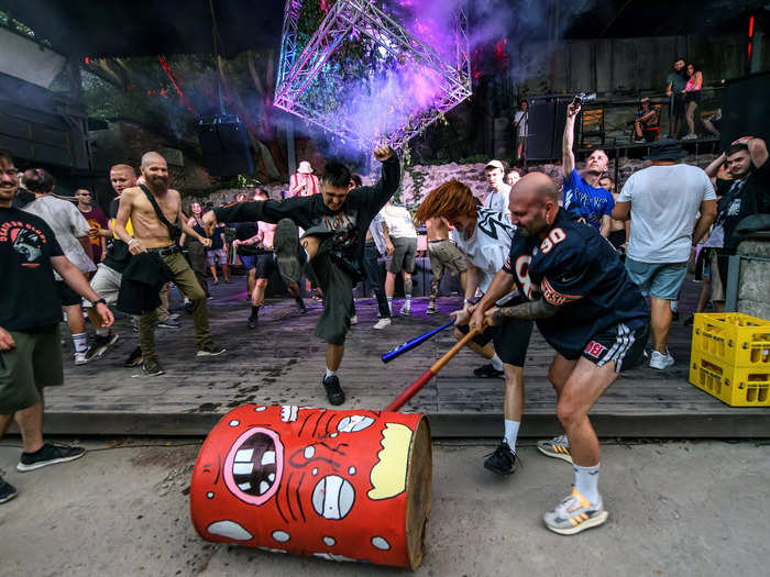 Ravers take their anger out on a Russia-themed barrel.