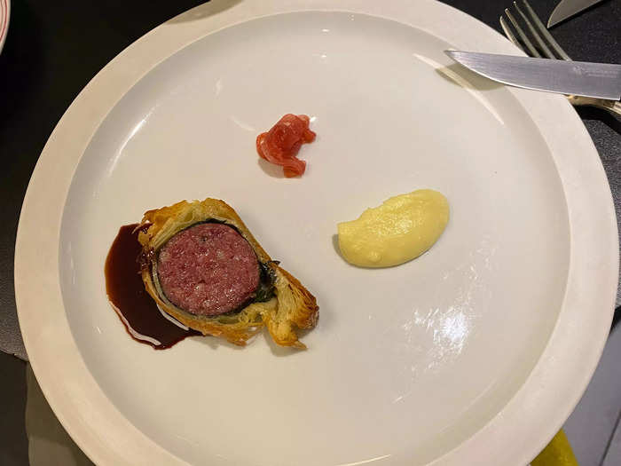 One course consisted of a slice of pork sausage and dollop of mashed potatoes.