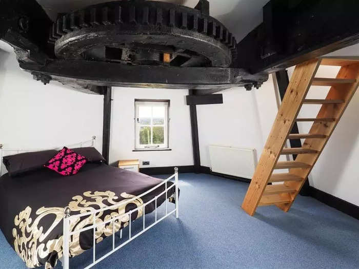 There are three bedrooms in the windmill, but the one on the third floor is the most unique as it has a giant exposed cog on its ceiling.