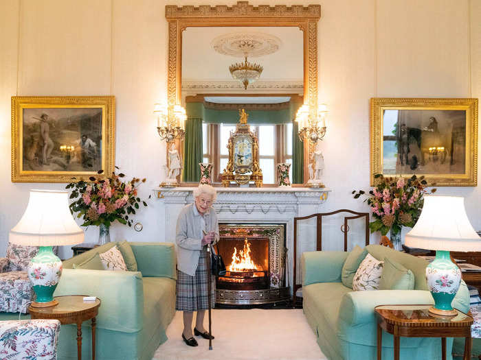 Inside the castle, the Queen receives guests in the castle