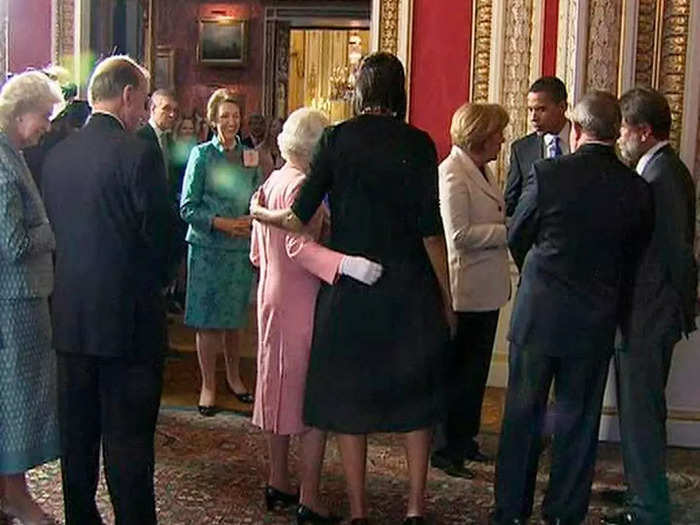 2009: First Lady Michelle Obama put her arm around the Queen as they posed for photos.