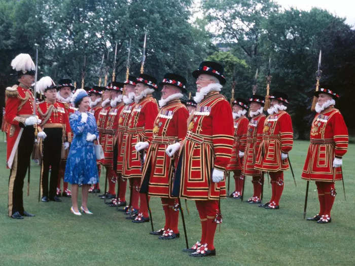 1978: Here, the Queen reviews her Yeoman of the Guard on the grounds of Buckingham Palace.