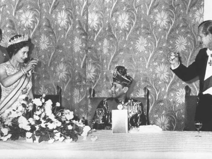 1974: Here, Queen Elizabeth II and the Duke of Edinburgh are pictured toasting the King of Malaysia, seated between them on July 12, 1974, at Claridge