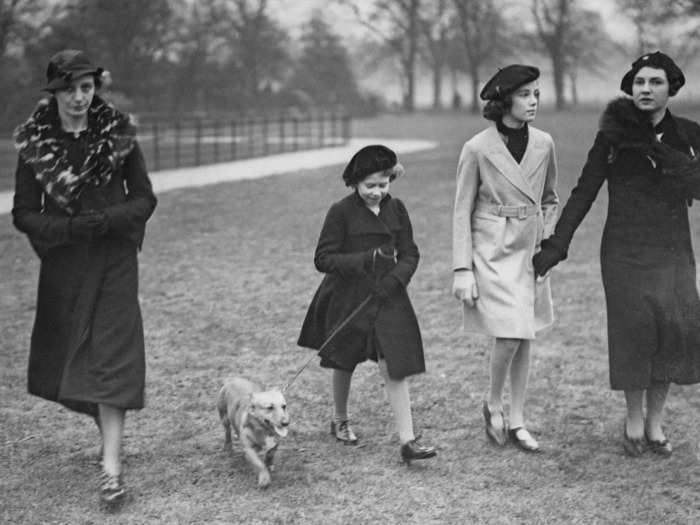 1936: In this picture, a young Elizabeth takes her pet dog for a walk in Hyde Park, London.