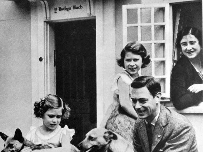 1933: This photo shows a young Elizabeth playing with her family