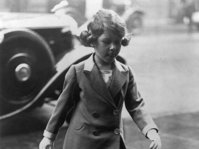 1932: Here, the young princess walks through the rain.