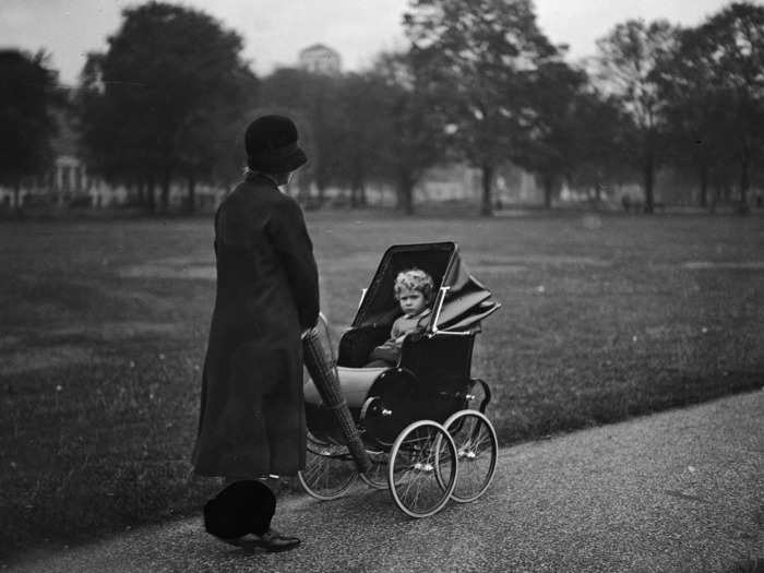 1929: In this photo, a young Elizabeth is strolled by her nanny in Green Park.